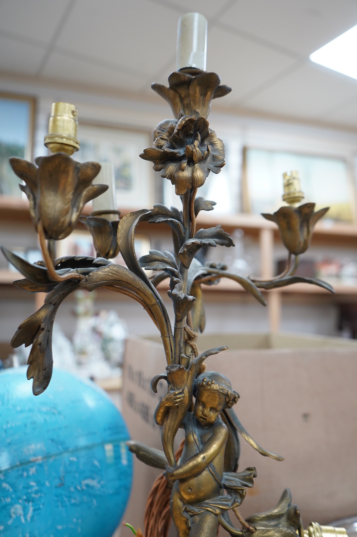 An early 20th century ormolu and marble ‘cherub’ converted candelabra and a brass desk stand, tallest 56cm